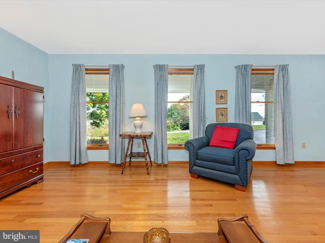 sitting room featuring light wood-type flooring and baseboards