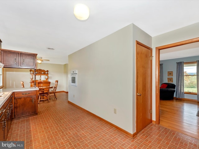 kitchen with light wood-type flooring and ceiling fan