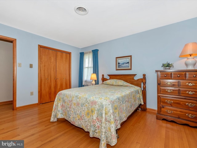 bedroom with a closet and light wood-type flooring