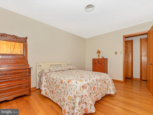 bedroom with visible vents, baseboards, and light wood-type flooring