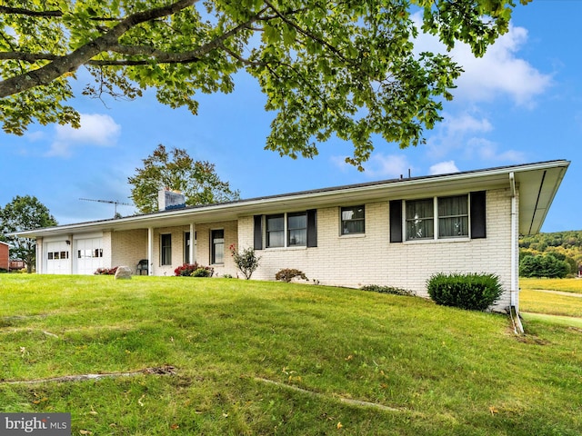 ranch-style home with a front yard and a garage