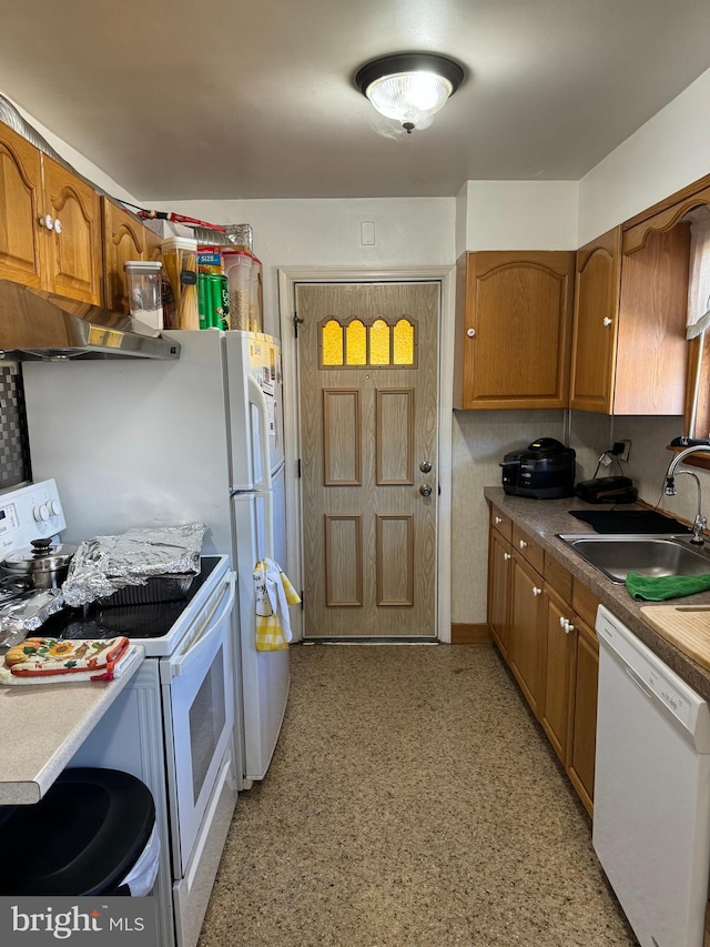 kitchen with sink, exhaust hood, and white appliances