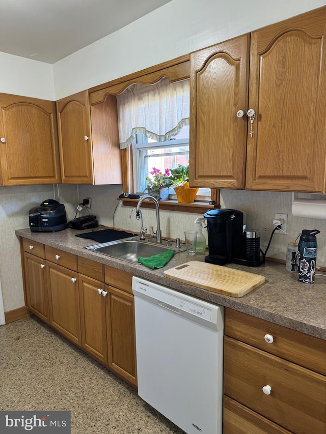 kitchen featuring white dishwasher and sink