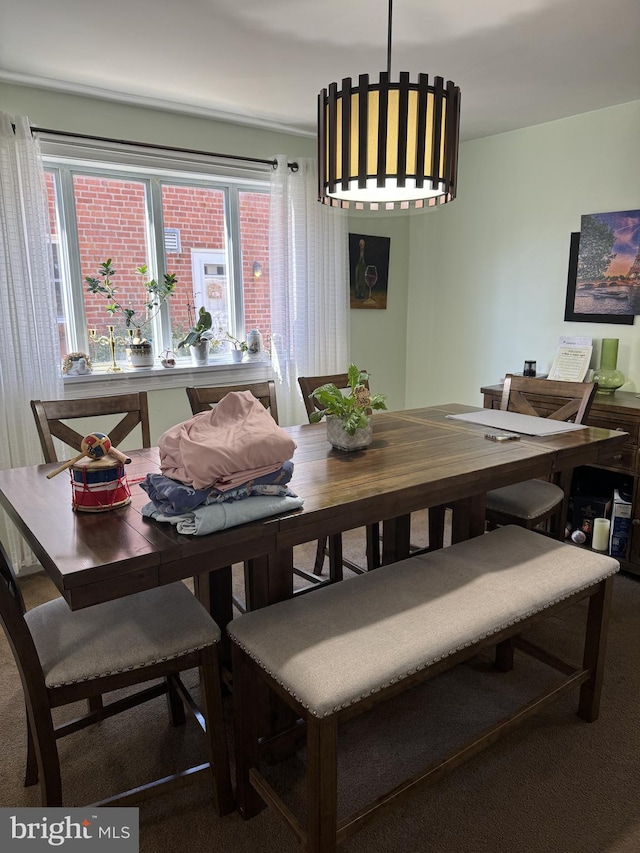 dining area featuring a wealth of natural light and carpet flooring