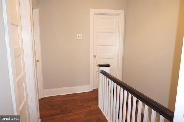 hall with dark wood-type flooring