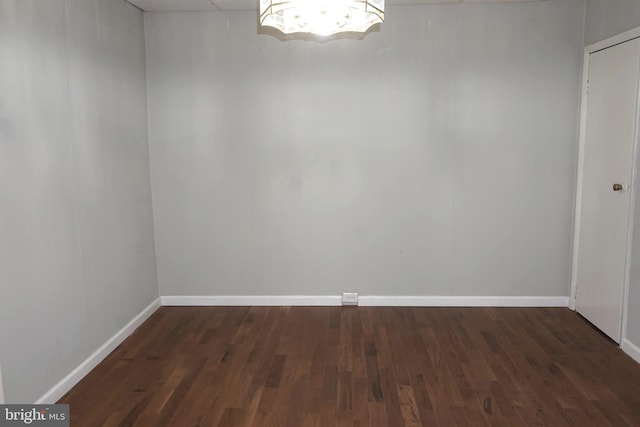 unfurnished room featuring dark hardwood / wood-style flooring