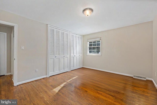 unfurnished bedroom with hardwood / wood-style floors