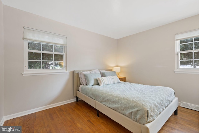 bedroom with hardwood / wood-style flooring