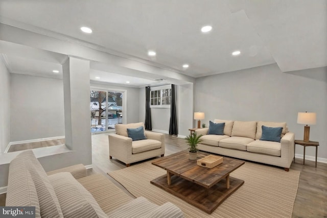 living room featuring light hardwood / wood-style flooring and ornamental molding