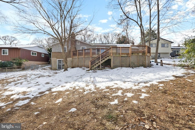 snow covered property with a wooden deck