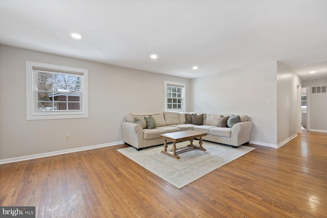 living room featuring a wealth of natural light and light wood-type flooring