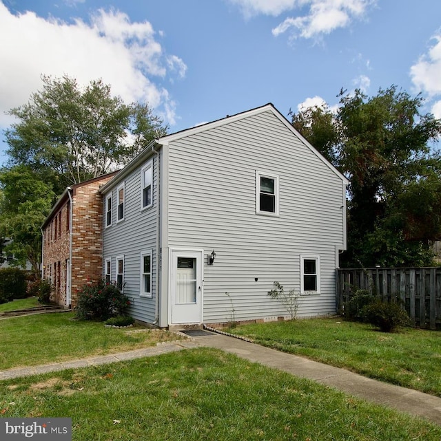 view of side of home with a lawn