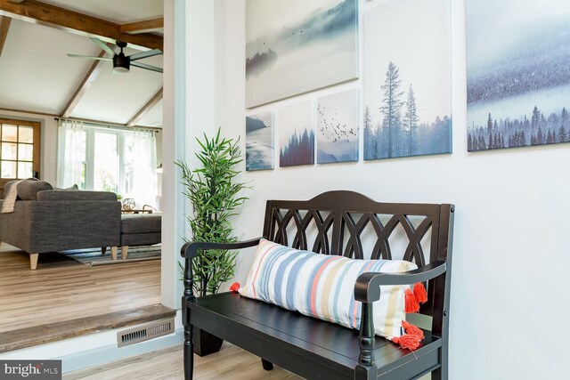 bedroom with lofted ceiling, visible vents, and wood finished floors