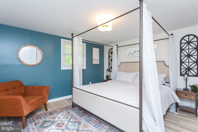 bedroom featuring baseboards and wood finished floors