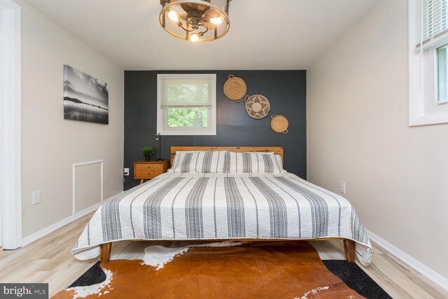 bedroom with wood finished floors and baseboards