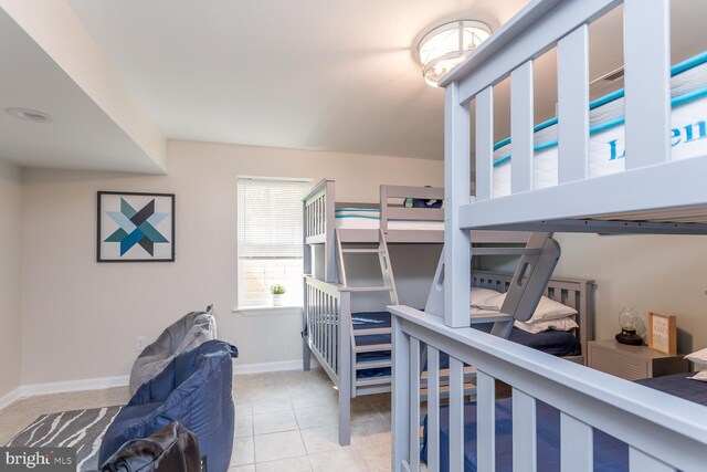 tiled bedroom featuring baseboards