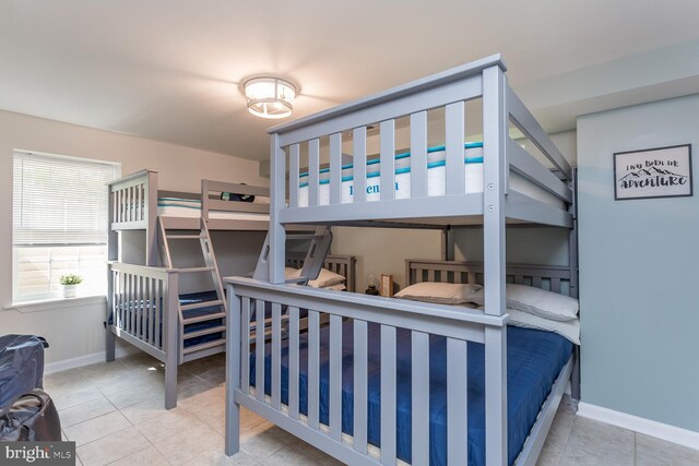 tiled bedroom featuring baseboards