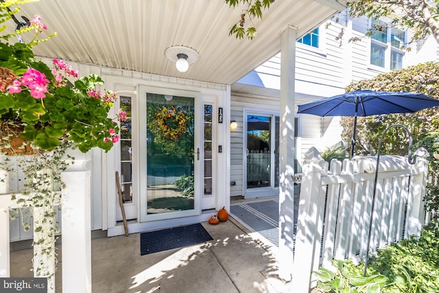 view of exterior entry with a patio area