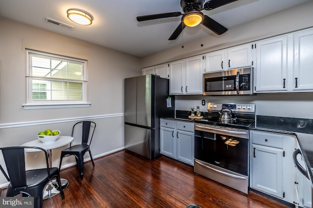 kitchen with white cabinets, ceiling fan, stainless steel appliances, and dark hardwood / wood-style flooring