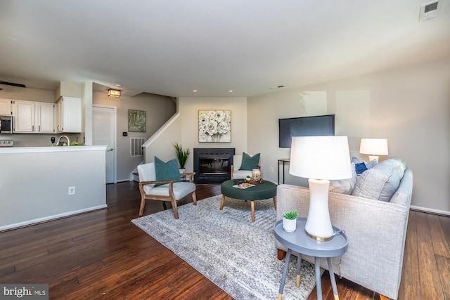 living room with sink and dark hardwood / wood-style floors