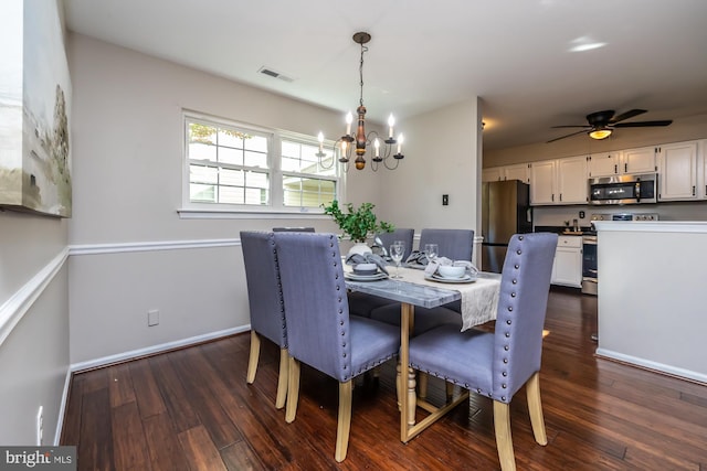 dining room with dark hardwood / wood-style floors and ceiling fan with notable chandelier