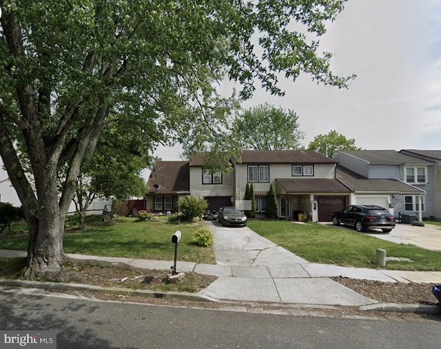 view of front facade with a front yard and a garage