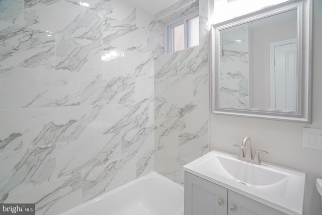 bathroom with vanity and tiled shower / bath