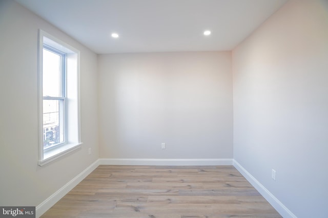 empty room with light wood-type flooring and a healthy amount of sunlight