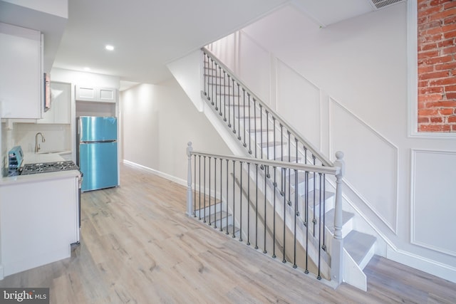 stairs featuring hardwood / wood-style flooring