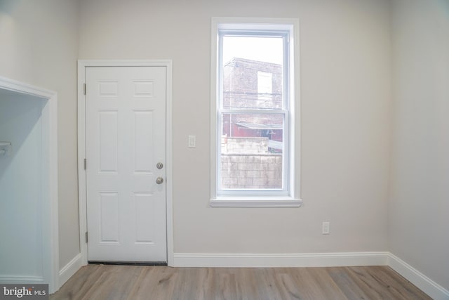 doorway with light wood-type flooring