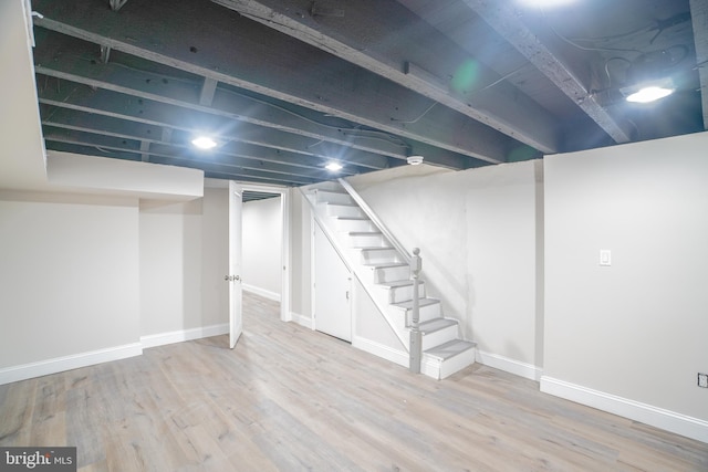 basement with light hardwood / wood-style floors