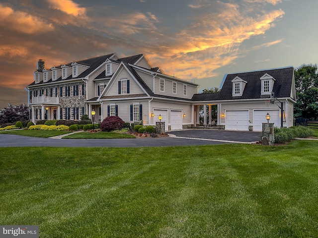 view of front of house featuring a garage and a yard