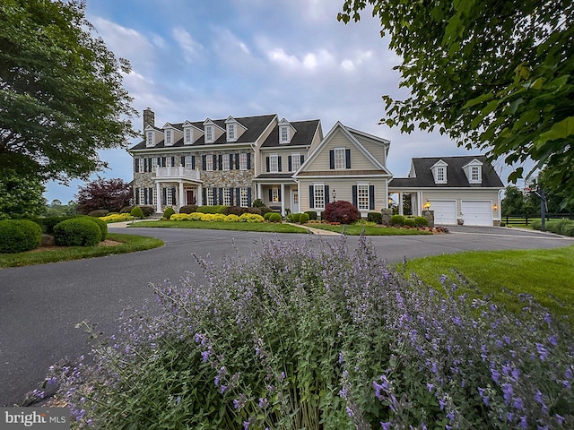 view of front of house featuring driveway and a chimney