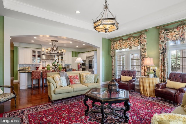 living room with hardwood / wood-style flooring, ornamental molding, and plenty of natural light