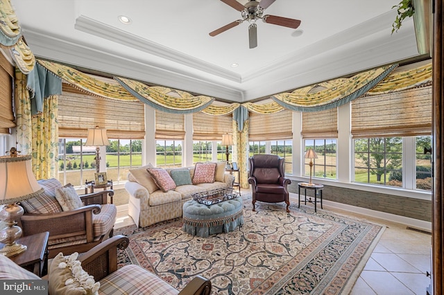 sunroom with a tray ceiling, plenty of natural light, and ceiling fan