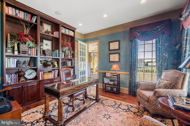 office with ornamental molding and light hardwood / wood-style floors