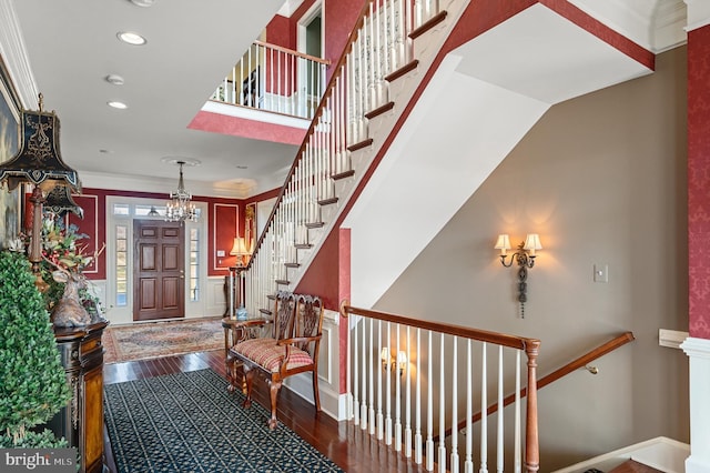entrance foyer with hardwood / wood-style flooring, baseboards, an inviting chandelier, and recessed lighting