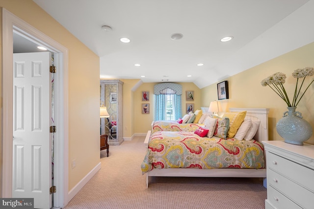 carpeted bedroom with vaulted ceiling