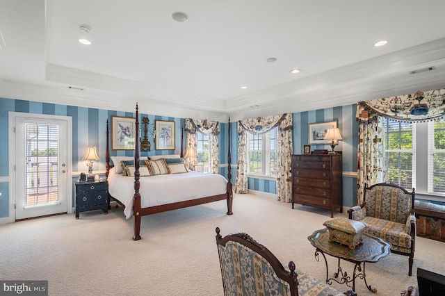 carpeted bedroom with ornamental molding, access to outside, and a tray ceiling