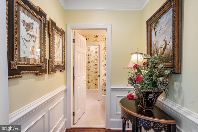 interior space featuring ornamental molding, a wainscoted wall, and tile patterned floors