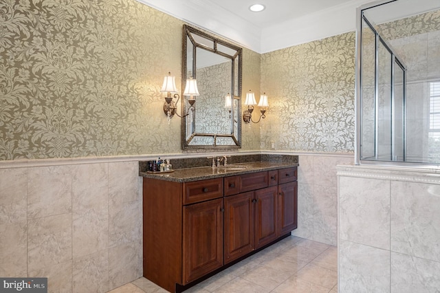 bathroom with vanity, an enclosed shower, tile patterned floors, and tile walls