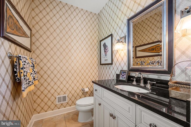 bathroom featuring toilet, visible vents, wallpapered walls, tile patterned flooring, and vanity