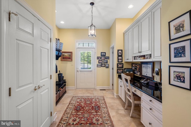 mudroom with baseboards, built in study area, recessed lighting, and light tile patterned floors