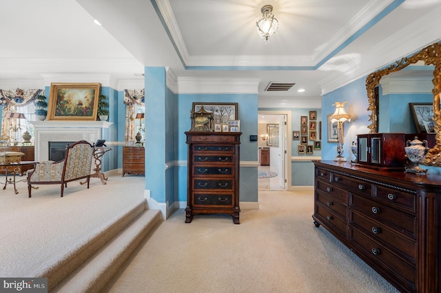 bedroom with a raised ceiling, visible vents, baseboards, a fireplace, and light colored carpet