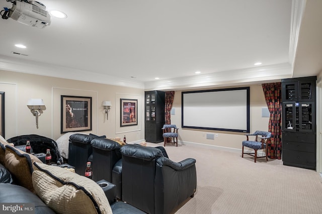 home theater room with crown molding and light carpet