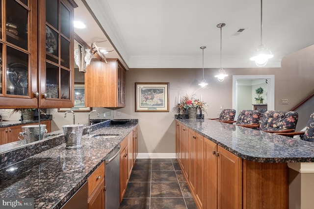 kitchen featuring sink, dark stone countertops, hanging light fixtures, stainless steel dishwasher, and kitchen peninsula