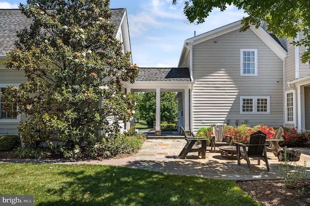 back of house with a patio and a yard