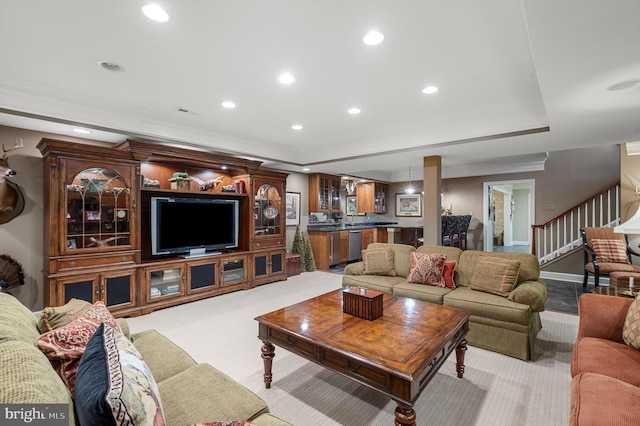 living area with carpet floors, recessed lighting, a raised ceiling, and stairway
