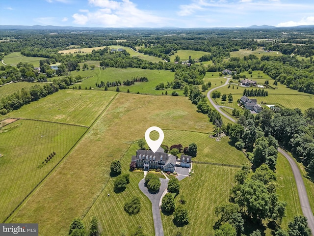 birds eye view of property with a rural view