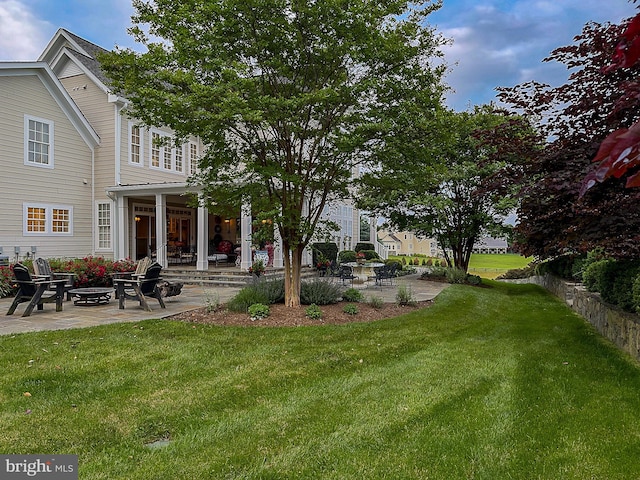 view of yard with a fire pit and a patio area